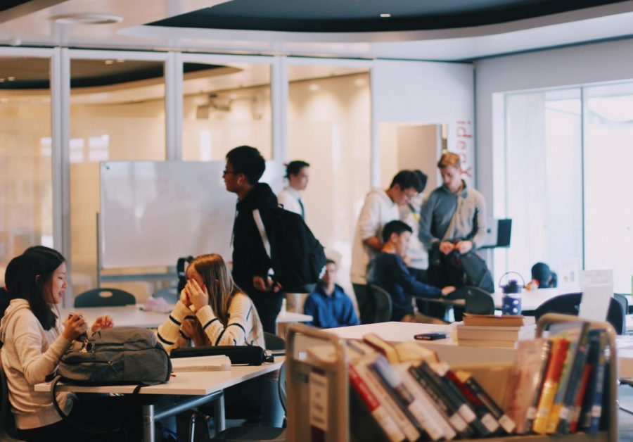 Students from grades 9 to 12 take a moment to chat or study in the library during the month of December, one of the busiest times of year for the popular location.