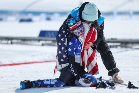 ZHANGJIAKOU, CHINA - FEBRUARY 20: Jessie Diggins of Team United States is attended to after collapsing after crossing the finish line and winning silver during the Womens Cross-Country Skiing 30k Mass Start Free on Day 16 of the Beijing 2022 Winter Olympics at The National Cross-Country Skiing Centre on February 20, 2022 in Zhangjiakou, China. (Photo by Patrick Smith/Getty Images)